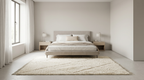 A minimalist bedroom featuring a light beige upholstered bed frame with white bedding, flanked by two matching bedside tables and lamps, set on a large cream shag rug in a bright, modern room.
